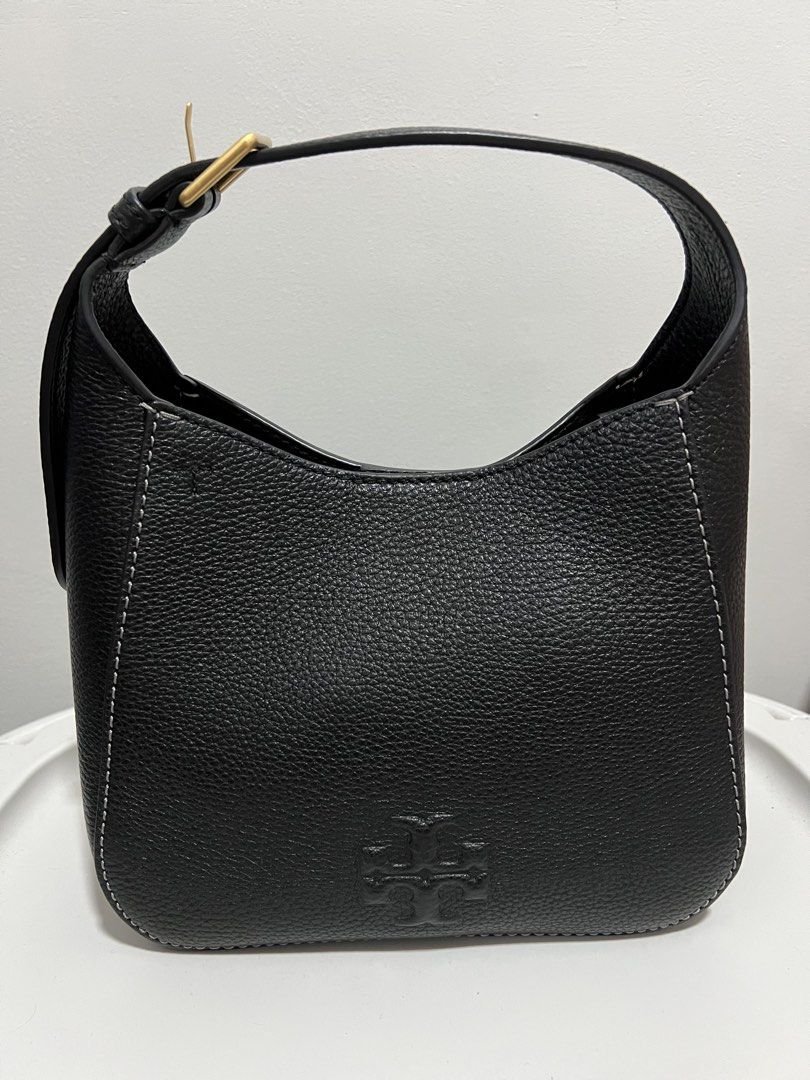 Authentic Tory Burch Black Leather Hobo Bag (Category: Luxury Bags & Wallets) located in Cebu City. Submitted by klingzy (Listing ID 1448824909, Image 1). Description: - Genuine black pebbled leather Tory Burch hobo bag - Elegant white contrast stitching throughout - Chic gold hardware detail on the strap - Embossed Tory Burch logo on the front - Timeless and simple design, ideal for daily use.