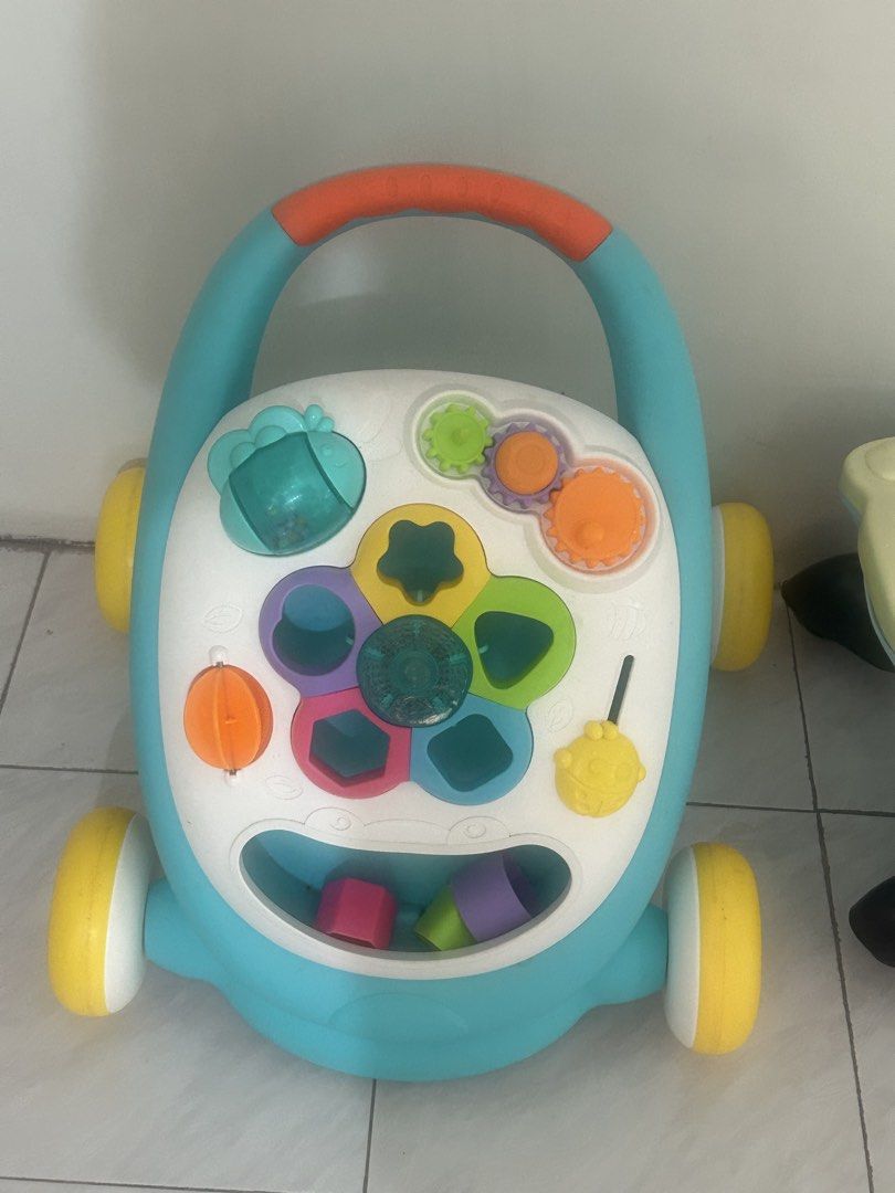 Baby Walker Activity Center with Shape Sorter and Gears (Category: Infant Playtime) located in Las Pinas. Submitted by jesuswasborn (Listing ID 1448748890, Image 1). Description: - Fun activity walker for babies - Features shape sorter with colored blocks - Includes spinning gears and a bead maze - Sturdy handle aids in learning to walk Di ko na makita ung star and square part. Rfs: migrating.
