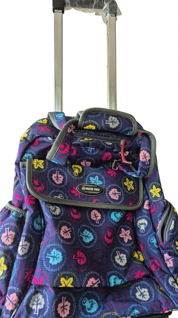 Backpack with rollers (Category: Backpacks) located in Singapore. Submitted by copycatz (Listing ID 1448730266, Image 2). Description: - Fun tree and leaf pattern on a navy blue base. - Colorful accents add a pop of style. - Features a top handle and wheels for effortless transport. - Perfect for school or travel adventures. - Ample interior space for all your essentials..
