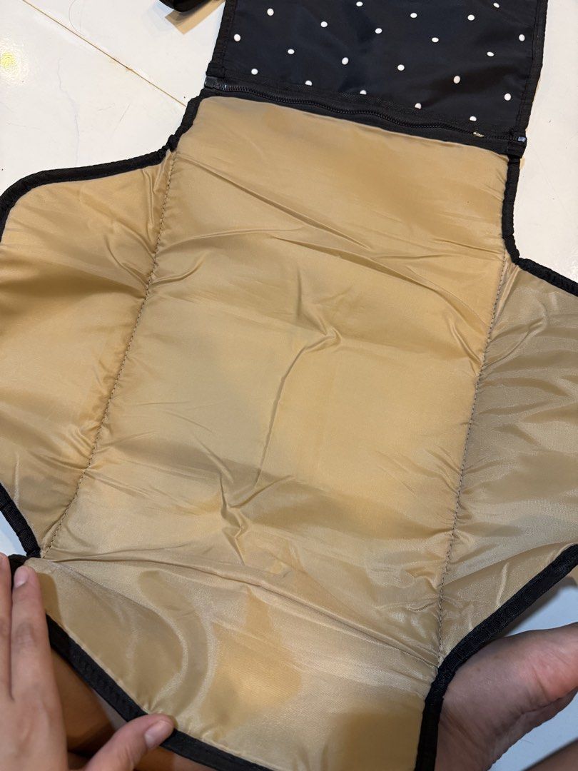Bebe Chic Black Polka Dot Changing Pad Clutch (Category: Changing Mats & Accessories) located in Carmona. Submitted by hannahamp (Listing ID 1448764345, Image 3). Description: - Black changing pad with white polka dots - Folds into a convenient clutch - Features a strap for stroller or bag attachment - Interior pockets for essentials - Includes a padded changing mat - Perfect for diaper changes on the go - Made with easy-to-clean material.