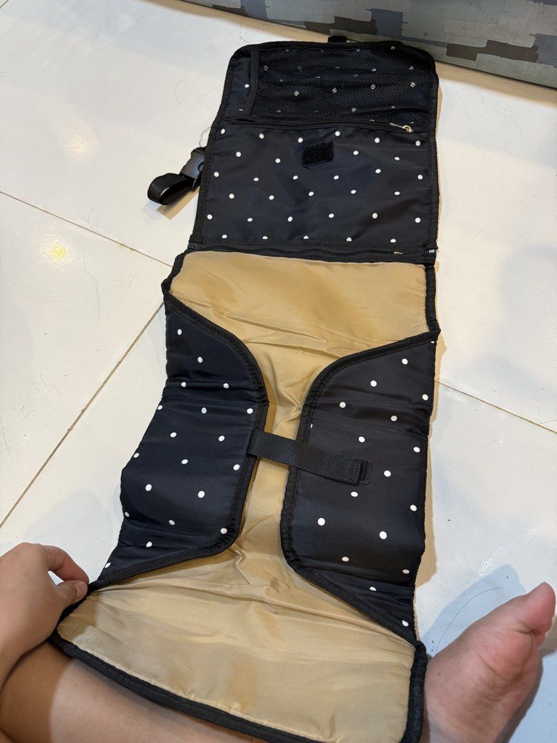 Bebe Chic Black Polka Dot Changing Pad Clutch (Category: Changing Mats & Accessories) located in Carmona. Submitted by hannahamp (Listing ID 1448764345, Image 2). Description: - Black changing pad with white polka dots - Folds into a convenient clutch - Features a strap for stroller or bag attachment - Interior pockets for essentials - Includes a padded changing mat - Perfect for diaper changes on the go - Made with easy-to-clean material.