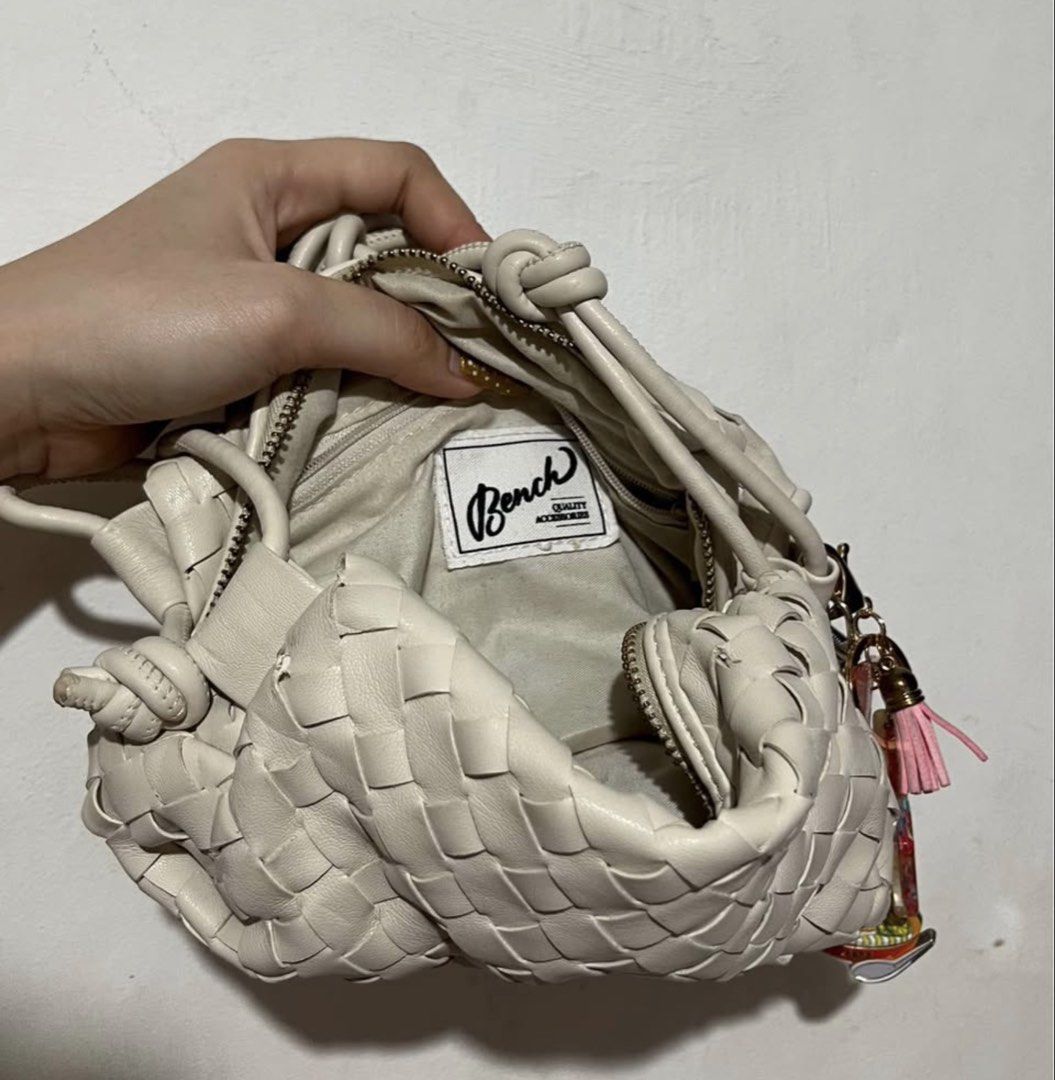 Bench Woven Crossbody Bag (Category: Cross-body Bags) located in Caloocan City. Submitted by ryspace (Listing ID 1448857588, Image 2). Description: - Cream-colored woven crossbody bag - Secure zip closure - Adjustable knotted strap - Detachable tassel charm - Interior zip pocket - Ideal for carrying your daily essentials.