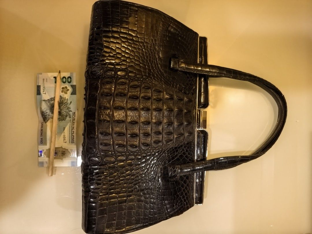 Black Real Crodile (Embossed) Handbag with Mirror (Category: Luxury Bags & Wallets) located in Tuguegarao City. Submitted by seagull2026 (Listing ID 1448701493, Image 2). Description: - Elegant black handbag with a luxurious crocodile embossed texture. - Features a secure and stylish clasp closure. - Comfortable to carry with two top handles. - Includes a practical interior zippered compartment for organization. - Comes with a handy small compact