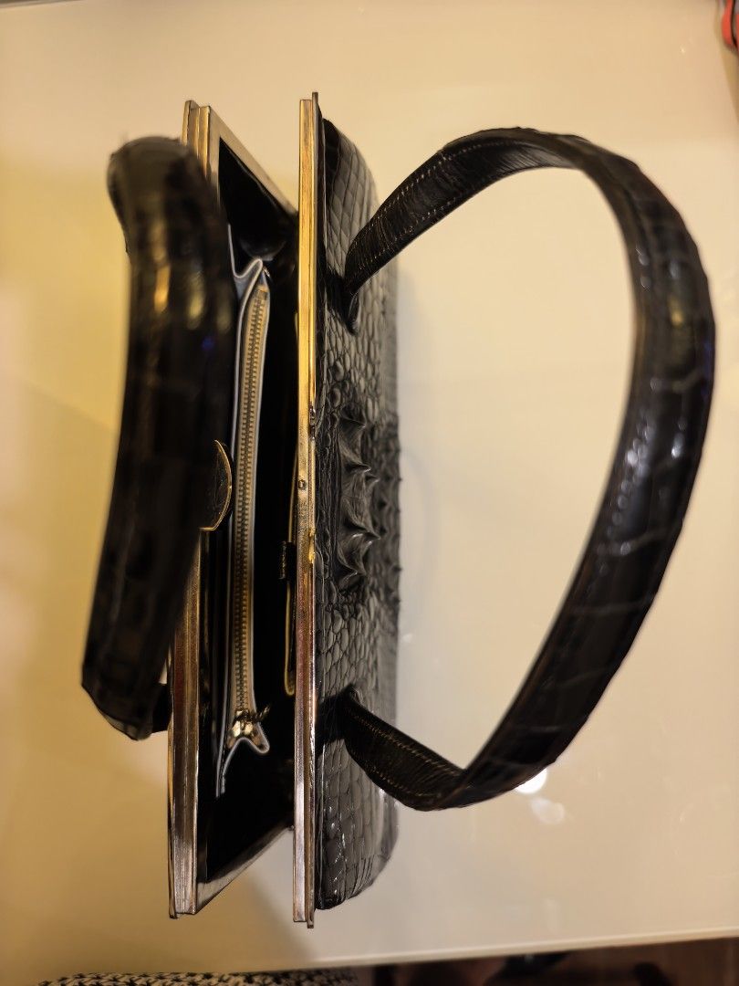 Black Real Crodile (Embossed) Handbag with Mirror (Category: Luxury Bags & Wallets) located in Tuguegarao City. Submitted by seagull2026 (Listing ID 1448701493, Image 3). Description: - Elegant black handbag with a luxurious crocodile embossed texture. - Features a secure and stylish clasp closure. - Comfortable to carry with two top handles. - Includes a practical interior zippered compartment for organization. - Comes with a handy small compact