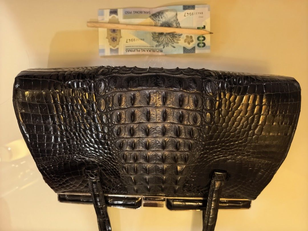 Black Real Crodile (Embossed) Handbag with Mirror (Category: Luxury Bags & Wallets) located in Tuguegarao City. Submitted by seagull2026 (Listing ID 1448701493, Image 1). Description: - Elegant black handbag with a luxurious crocodile embossed texture. - Features a secure and stylish clasp closure. - Comfortable to carry with two top handles. - Includes a practical interior zippered compartment for organization. - Comes with a handy small compact