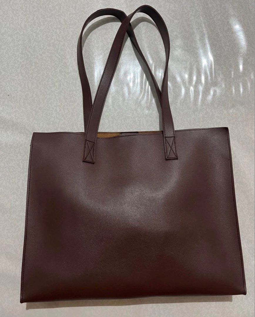 Brown Leather Tote Bag (Category: Tote Bags) located in Caloocan City. Submitted by ryspace (Listing ID 1448858030, Image 1). Description: - Classic brown leather tote - Spacious interior with a small pocket - Magnetic snap closure - Simple and functional design - Great for everyday use or work.