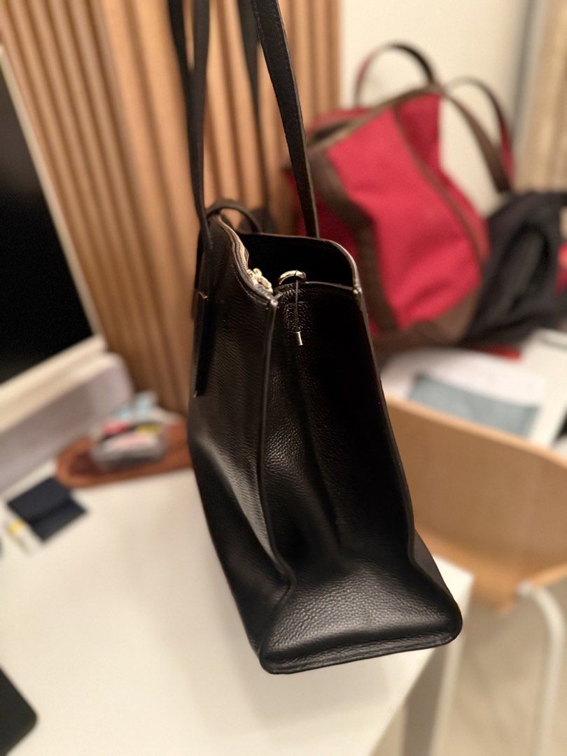 Coach Black Leather Tote Bag with Turnlock Closure (Category: Tote Bags) located in Mandaluyong City. Submitted by geri3373 (Listing ID 1448838818, Image 3). Description: - Brand: Coach - Material: Black pebbled leather - Closure: Front turnlock flap and zip-top main compartment - Interior: Fabric lining - Features: Coach leather hangtag - Ideal for: Everyday use or work.