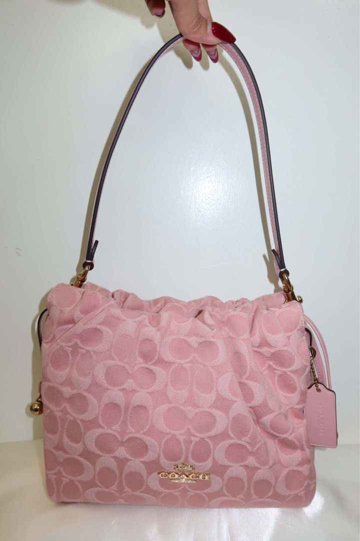 Coach Faye Pink denim (Category: Cross-body Bags) located in Santiago. Submitted by dobongsoon (Listing ID 1448789575, Image 2). Description: - Cute pink Coach bag - Signature C monogram pattern - Drawstring closure - Adjustable strap - Small Coach hang tag - Gold hardware details - Great for everyday use.