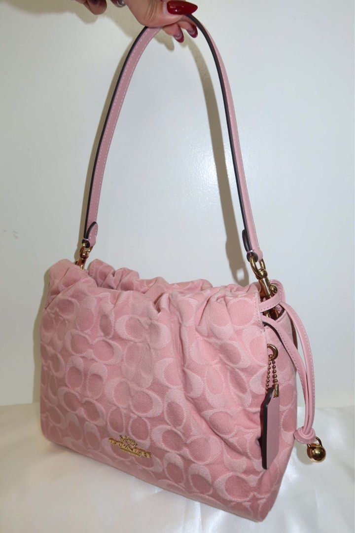 Coach Faye Pink denim (Category: Cross-body Bags) located in Santiago. Submitted by dobongsoon (Listing ID 1448789575, Image 1). Description: - Cute pink Coach bag - Signature C monogram pattern - Drawstring closure - Adjustable strap - Small Coach hang tag - Gold hardware details - Great for everyday use.