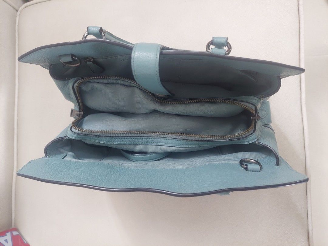 Coach Leather Satchel Handbag (Category: Luxury Bags & Wallets) located in Antipolo. Submitted by alaljr (Listing ID 1448715696, Image 3). Description: Coach Mercer Satchel 30 - Color: Teal/Cloud Blue - Material: Grain Leather - Style: Satchel/Crossbody/Handbag - Features: Top handle, buckle closure strap - Interior: Zippered compartment, additional pockets - Condition: Clean inside and out - Size: Perfect for everyday use.