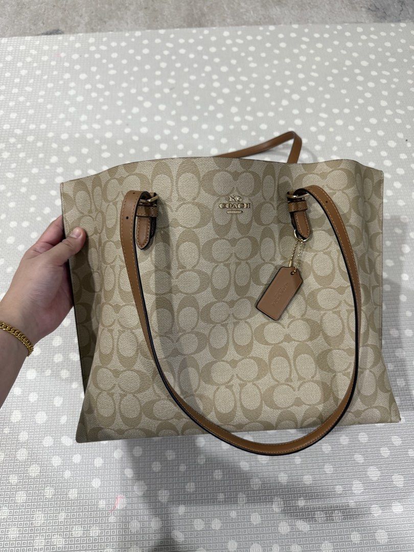 Coach Mollie Tote In Signature Canvas Light Khaki/Saddle (Category: Bags & Wallets) located in Kuala Lumpur. Submitted by faraahunny (Listing ID 1448836455, Image 1). Description: - Coach Mollie Tote Bag - Signature canvas in light khaki and saddle brown - Includes Coach hangtag - Original price visible on receipt - Bought it RM1.1k - Selling it half price: RM600 - My loss, your gain! - Arrange self-pickup @ Taman Melawati, KL -Strictly no lowbal