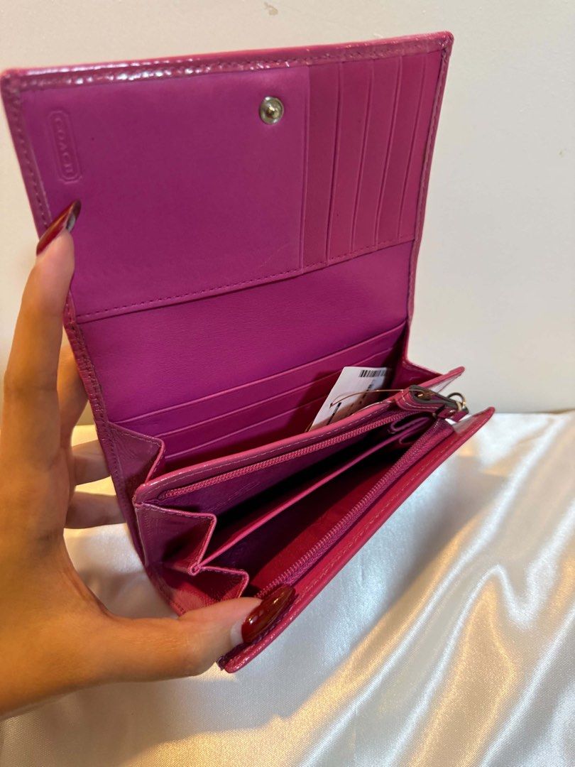 Coach Pink Patent Leather Bifold Wallet (Category: Purses & Pouches) located in Santiago. Submitted by dobongsoon (Listing ID 1448753291, Image 3). Description: - Pink patent leather Coach wallet - Bifold style with snap closure - Multiple card slots - Zippered coin pocket - Pink interior.