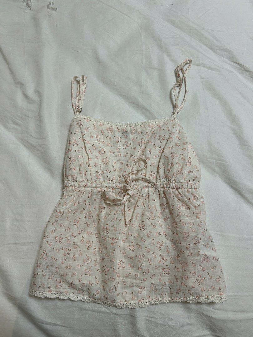 cotton on floral tank top (Category: Sleeveless) located in Manila. Submitted by ayannadeclutters (Listing ID 1448868239, Image 2). Description: - rarely worn - light pink and white floral design - comes with tie in the front and plain at the back - fitted in chest; flowy bottom fit .