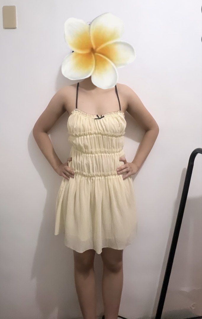 Cream Ruched Mini Dress with Black Straps (Category: Dresses) located in Makati City. Submitted by g.ang.s (Listing ID 1442474842, Image 3). Description: - Cream colored mini dress - Ruched detailing on bodice - Gathered waist - Thin black spaghetti straps with small black bow at bust - Lightweight and flowy fabric - Versatile for casual outings or nights out.