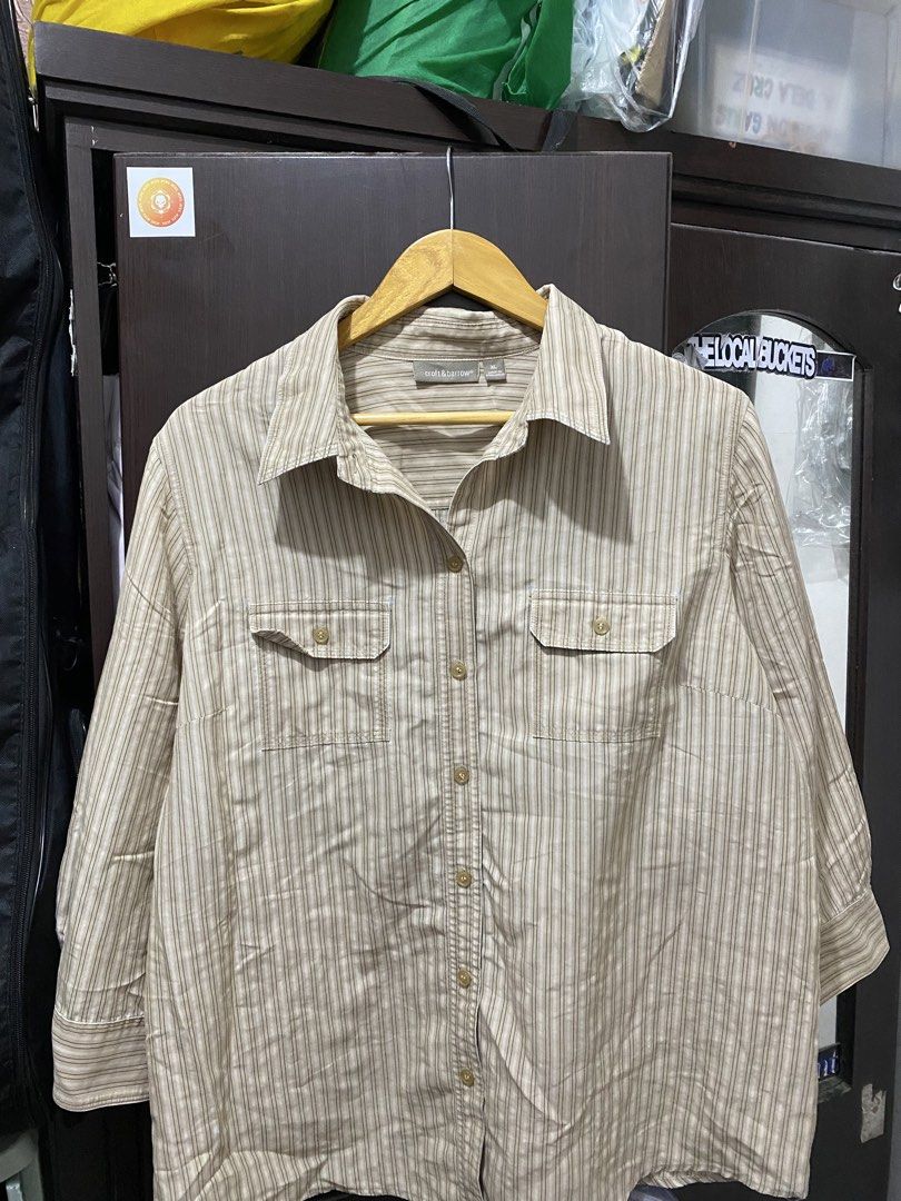 Croft & Barrow Striped Button-Up Shirt (Category: Tshirts & Polo Shirts ) located in Cavite. Submitted by grabanddeclutter (Listing ID 1448835637, Image 1). Description: - Subtle beige and brown vertical stripe pattern - Two chest pockets with button closures - Three-quarter length sleeves - No issues!! Perfect for casual wear or layering!! - Dimensions: Width 23 Length 26.5 No COD gcash payment Plus shipping fee Jnt or lalamove.