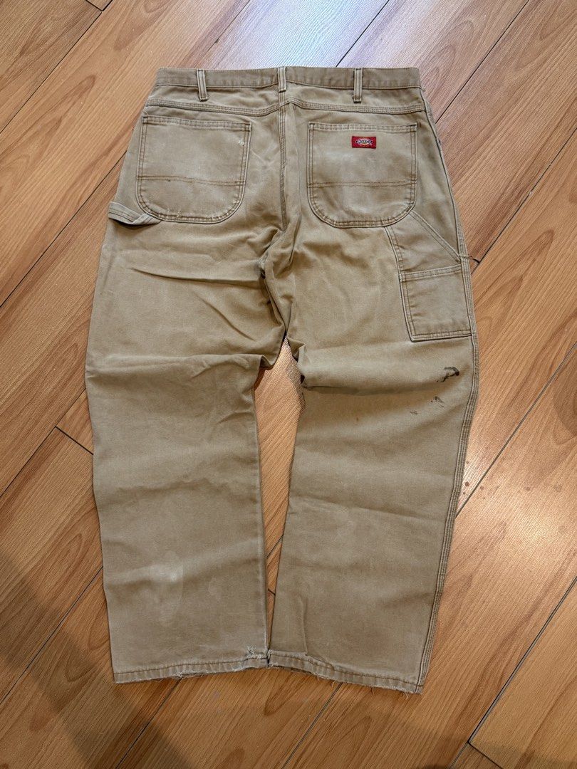 Dickies Carpenter Pants Tan Workwear (Category: Jeans) located in Cebu City. Submitted by aweful.wire (Listing ID 1448707098, Image 2). Description: Dickies Light Khaki Carpenter Pants Red Patch WxL 36x42 Leg Opening: 9.5 - Tan Dickies carpenter pants - Classic workwear style - Iconic Dickies logo patch on back pocket - Plenty of pockets for tools or essentials - Durable fabric - Bottom hems are frayed.