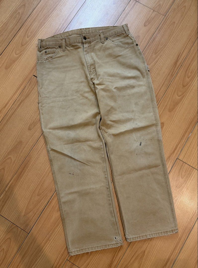 Dickies Carpenter Pants Tan Workwear (Category: Jeans) located in Cebu City. Submitted by aweful.wire (Listing ID 1448707098, Image 3). Description: Dickies Light Khaki Carpenter Pants Red Patch WxL 36x42 Leg Opening: 9.5 - Tan Dickies carpenter pants - Classic workwear style - Iconic Dickies logo patch on back pocket - Plenty of pockets for tools or essentials - Durable fabric - Bottom hems are frayed.