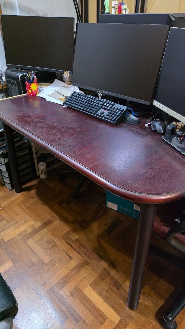 Dining table, Study Table (Category: Tables & Sets) located in Singapore. Submitted by jimmychen50 (Listing ID 1448731982, Image 1). Description: - Spacious curved desk - Dark red textured surface - Used to be my dining table, then kids tuition table, now study table - Ample surface area for work or gaming - Perfect for home office setup - 140 x 90 x 80 cm LBH.