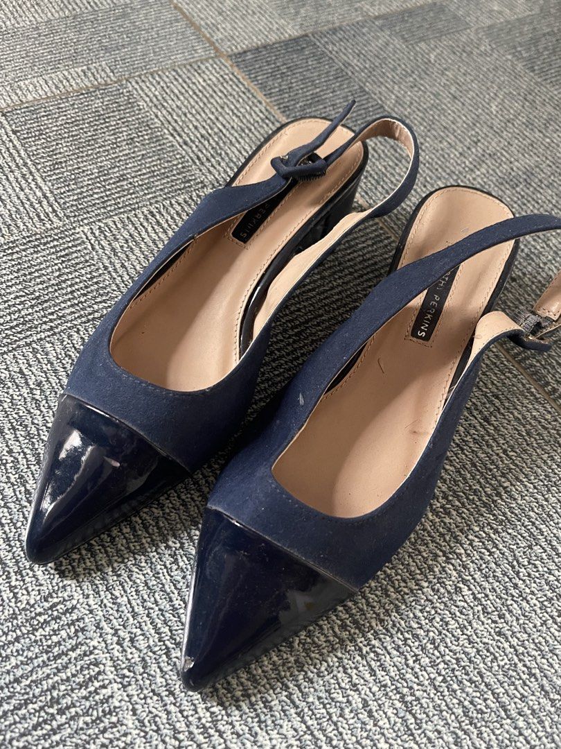 Dorothy Perkins Navy Blue Slingback Heels (Category: Heels) located in Tagaytay City. Submitted by janey_22 (Listing ID 1448838200, Image 1). Description: - Navy blue slingback heels from Dorothy Perkins - Chic pointed toe with a glossy patent finish - Secure and adjustable strap with buckle closure - Comfortable low heel for all-day wear - Versatile: ideal for office or evening events.