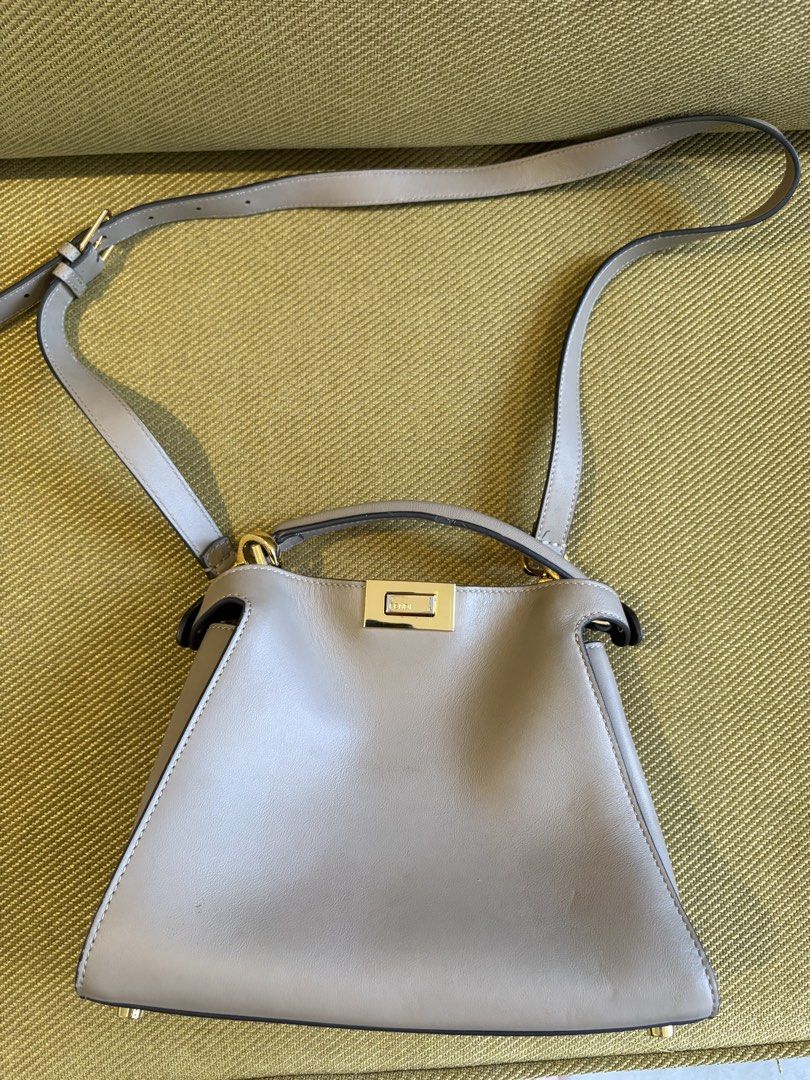 Fendi Peekaboo Bag Taupe Leather (Category: Luxury Bags & Wallets) located in Makati City. Submitted by rumnougat (Listing ID 1448843555, Image 1). Description: - Authentic Fendi Peekaboo Bag - Color: Taupe - Material: Genuine Leather - Hardware: Gold - Iconic Fendi Clasp - Features: Top handle and detachable shoulder strap - Interior: Black - Condition: Good - Versatile: Ideal for everyday or special occasions BAG ONLY No more bag pouch 💯 guara