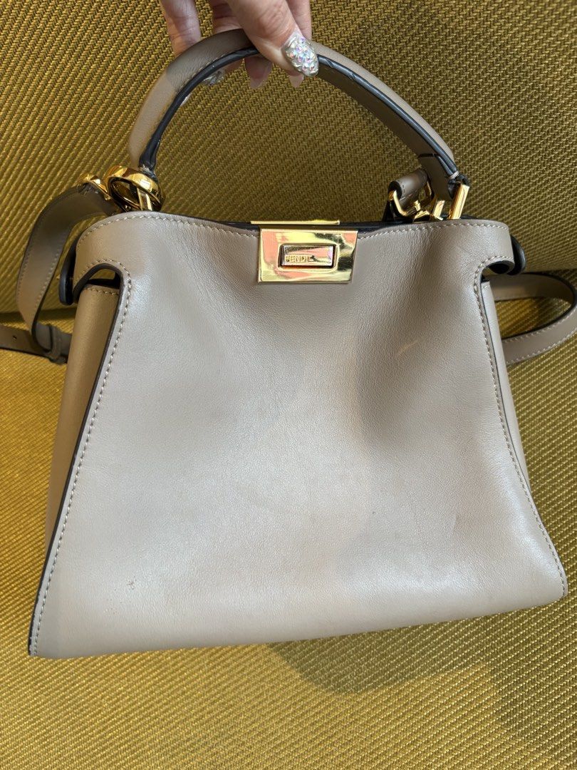 Fendi Peekaboo Bag Taupe Leather (Category: Luxury Bags & Wallets) located in Makati City. Submitted by rumnougat (Listing ID 1448843555, Image 2). Description: - Authentic Fendi Peekaboo Bag - Color: Taupe - Material: Genuine Leather - Hardware: Gold - Iconic Fendi Clasp - Features: Top handle and detachable shoulder strap - Interior: Black - Condition: Good - Versatile: Ideal for everyday or special occasions BAG ONLY No more bag pouch 💯 guara
