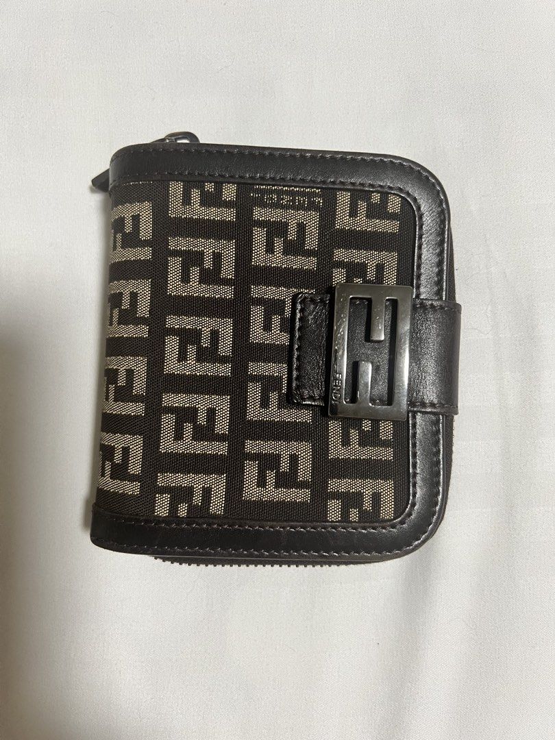 Fendi Zucca Monogram Compact Wallet (Category: Luxury Bags & Wallets) located in Manila. Submitted by goldenriver_777 (Listing ID 1448708755, Image 3). Description: Fendi Classic Zucca canvas with brown leather trim - Bifold style with zip-around coin pocket - Very compact with multiple card slots inside - Silver Fendi logo hardware - Great for everyday use Well used but in good condition Self-authenticated, bought preloved *** photo enhanced by 