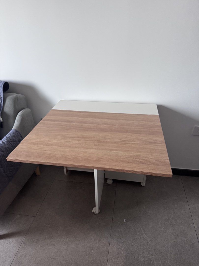 Foldable Dining Table with Wheels (Category: Tables & Sets) located in Singapore. Submitted by ter85ter (Listing ID 1448776921, Image 2). Description: - Compact and foldable design, ideal for small homes. - Versatile use: dining table or extra workspace. - Built-in wheels for effortless mobility. - Folds flat for convenient storage. - Stylish wood grain finish with a clean white top. .
