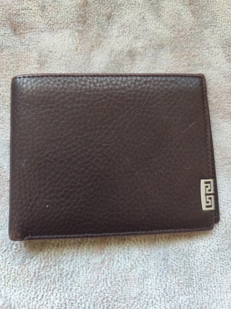 Gold lion Brown Leather Bifold Wallet (Category: Luxury Bags & Wallets) located in Carmona. Submitted by francesantoniette (Listing ID 1448805237, Image 1). Description: - Genuine Givenchy brown leather bifold wallet - Iconic Givenchy logo on the front - Ample card slots for all your essentials - Subtle patterned interior lining - Ideal for everyday carry and style.