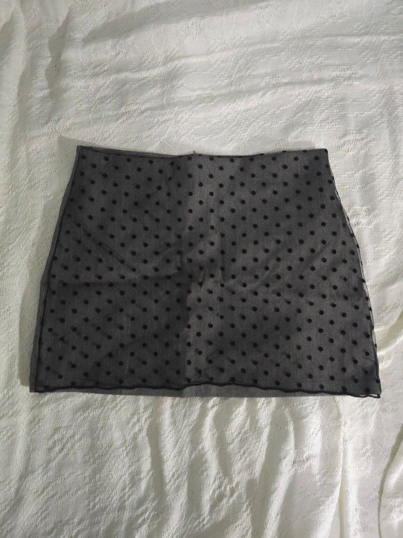 Grey Polka Dot Sheer Overlay Mini Skirt (Category: Skirts) located in Meycauayan. Submitted by saurfee (Listing ID 1448809290, Image 1). Description: - Grey mini skirt - Sheer polka dot overlay - Side zipper closure - Size L but run small - Has built in inner shorts - Never used out, just fitted - Estimated size: Medium - Waist 28 in, Hips 34 in, Length 13 in (1-2 cm measurement difference).
