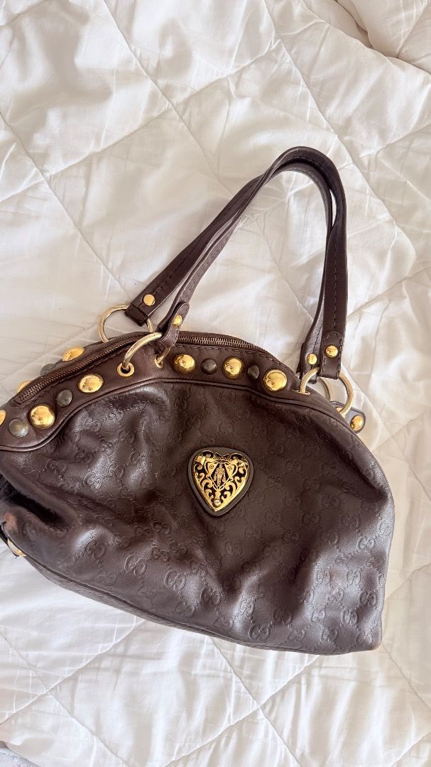 Gucci Babouska Heart Tote (Category: Luxury Bags & Wallets) located in Manila. Submitted by deemfp (Listing ID 1448747724, Image 1). Description: - Authentic brown leather Gucci shoulder bag - All-over iconic Gucci monogram pattern - Elegant gold heart emblem and stud details - Playful, patterned interior lining - Comfortable shoulder straps for easy carrying - Shows some wear on the bottom corners, adding character - Ideal for everyday use, styl