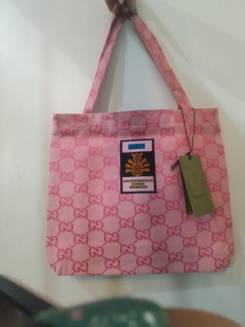 Gucci Pink GG Monogram Tote Bag (Category: Luxury Bags & Wallets) located in Caloocan City. Submitted by refreshmycloset444 (Listing ID 1448717034, Image 1). Description: - Authentic Pink Gucci Tote Bag GWP - Features iconic GG monogram pattern - Unique central patch with pineapple and "22 Thousand Hundred and Five Gucci Songs" text - Comes with original tags - Ideal for everyday use.