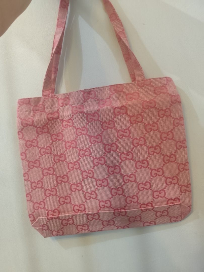 Gucci Pink GG Monogram Tote Bag (Category: Luxury Bags & Wallets) located in Caloocan City. Submitted by refreshmycloset444 (Listing ID 1448717034, Image 2). Description: - Authentic Pink Gucci Tote Bag GWP - Features iconic GG monogram pattern - Unique central patch with pineapple and "22 Thousand Hundred and Five Gucci Songs" text - Comes with original tags - Ideal for everyday use.