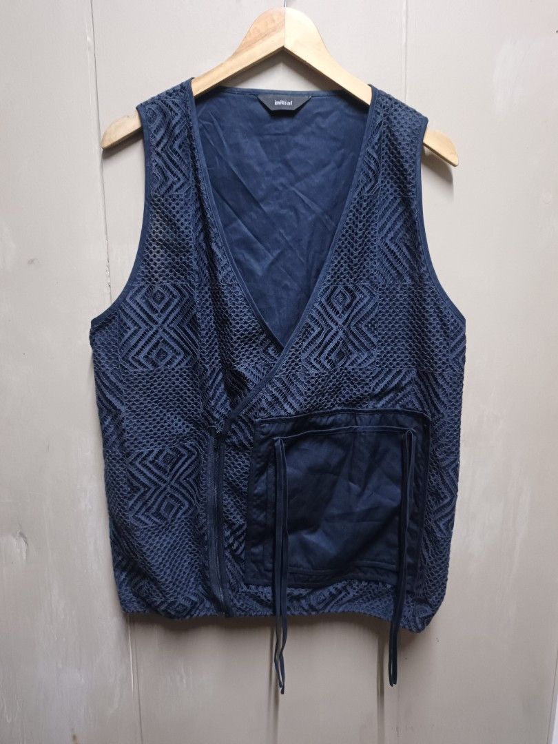 INITIAL Navy Blue Textured Wrap Vest (Category: Vests) located in Dasmarinas. Submitted by jessicamae43174 (Listing ID 1448824465, Image 1). Description: - Brand: INITIAL - Width 20.5 Length 27 - Color: Navy Blue - Design: Textured geometric pattern all over - Style: Wrap front with drawstring tie at waist, sleeveless - Material: 55% Cotton, 45% Nylon - Perfect for layering.