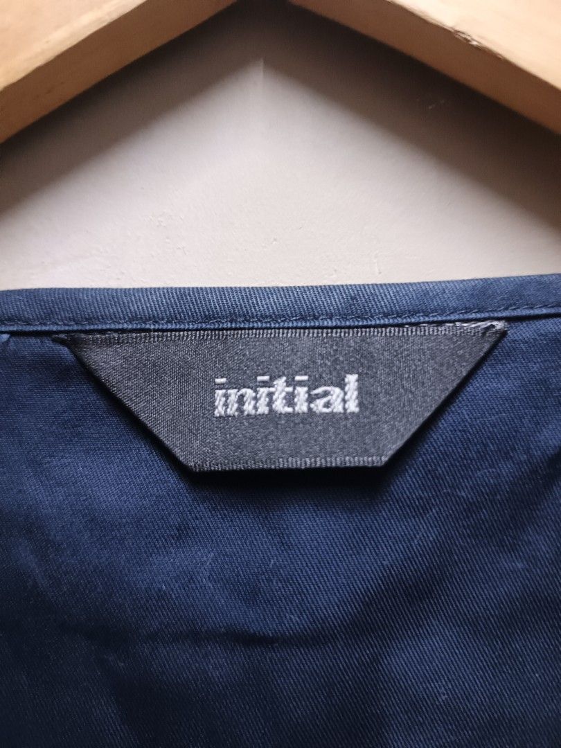 INITIAL Navy Blue Textured Wrap Vest (Category: Vests) located in Dasmarinas. Submitted by jessicamae43174 (Listing ID 1448824465, Image 3). Description: - Brand: INITIAL - Width 20.5 Length 27 - Color: Navy Blue - Design: Textured geometric pattern all over - Style: Wrap front with drawstring tie at waist, sleeveless - Material: 55% Cotton, 45% Nylon - Perfect for layering.