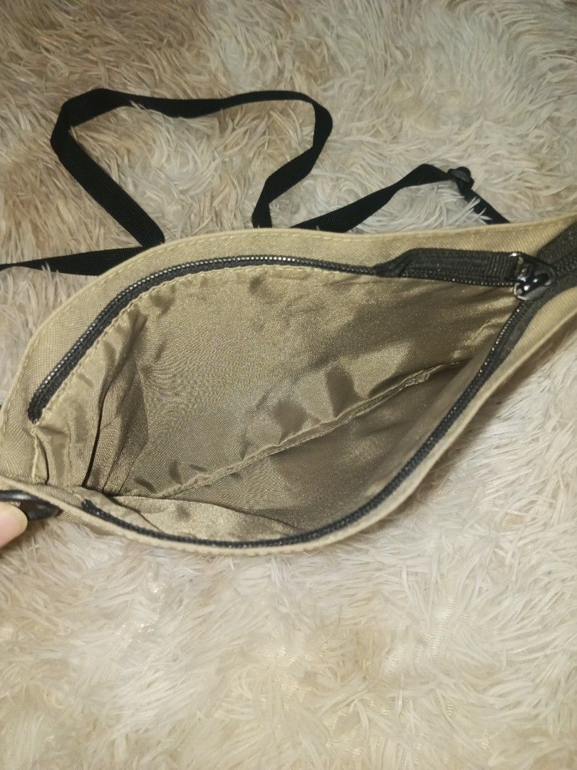 Khaki Canvas Crossbody Bag with Black Strap (Category: Cross-body Bags) located in Quezon City. Submitted by cxthsells (Listing ID 1448815926, Image 2). Description: - Simple khaki canvas crossbody bag - Main zippered compartment - Inner pocket for organization - Adjustable black strap for comfortable wear - Ideal for carrying everyday essentials - needs cleaning.