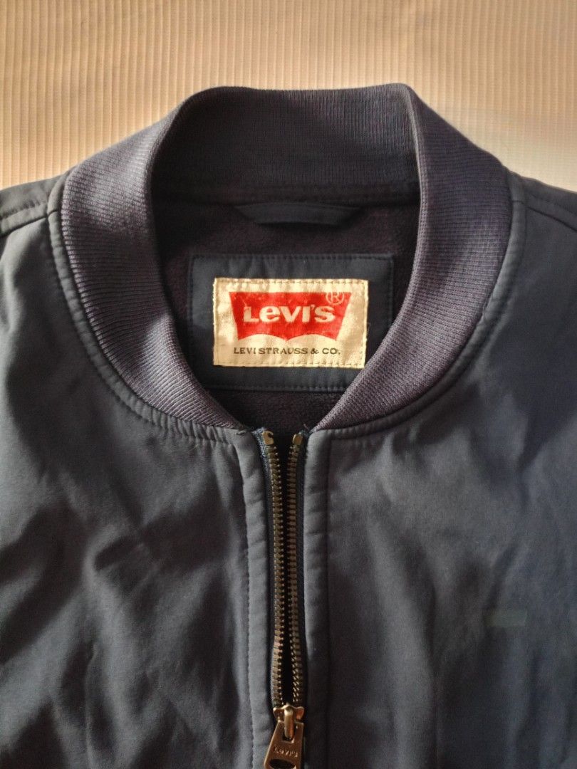 Levi's Bomber Jacket Navy Blue (Category: Coats, Jackets and Outerwear) located in Caloocan City. Submitted by grandturtle-371b8d (Listing ID 1448765488, Image 2). Description: - Levi's Navy Blue Bomber Jacket - Zip-up front with convenient pockets - Features ribbed collar, cuffs, and hem for a classic look - Material: Shell (94% Polyester, 6% Spandex), Lining (100% Polyester) - Care: Machine wash cold, cool iron if needed - Ideal for everyday ca