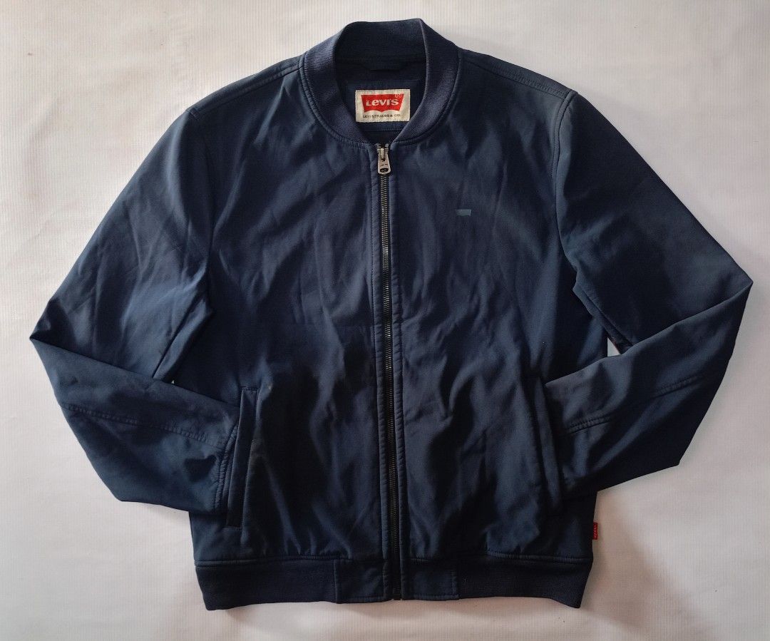 Levi's Bomber Jacket Navy Blue (Category: Coats, Jackets and Outerwear) located in Caloocan City. Submitted by grandturtle-371b8d (Listing ID 1448765488, Image 1). Description: - Levi's Navy Blue Bomber Jacket - Zip-up front with convenient pockets - Features ribbed collar, cuffs, and hem for a classic look - Material: Shell (94% Polyester, 6% Spandex), Lining (100% Polyester) - Care: Machine wash cold, cool iron if needed - Ideal for everyday ca