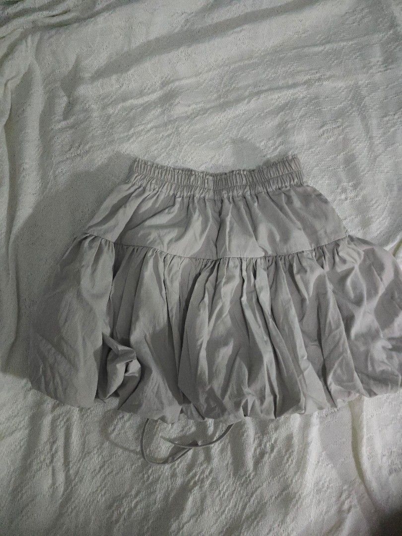Light Gray Bubble Ribbon Tie Mini Skirt (Category: Skirts) located in Meycauayan. Submitted by saurfee (Listing ID 1448810257, Image 2). Description: - Waist: 55-85 cm - Light grey skirt - Bubble design - Comfortable elastic waistband - Side drawstring detail - Only used once - Has inner shorts - Bought for PHP 850 - Estimated size: Medium - Ideal for casual wear.