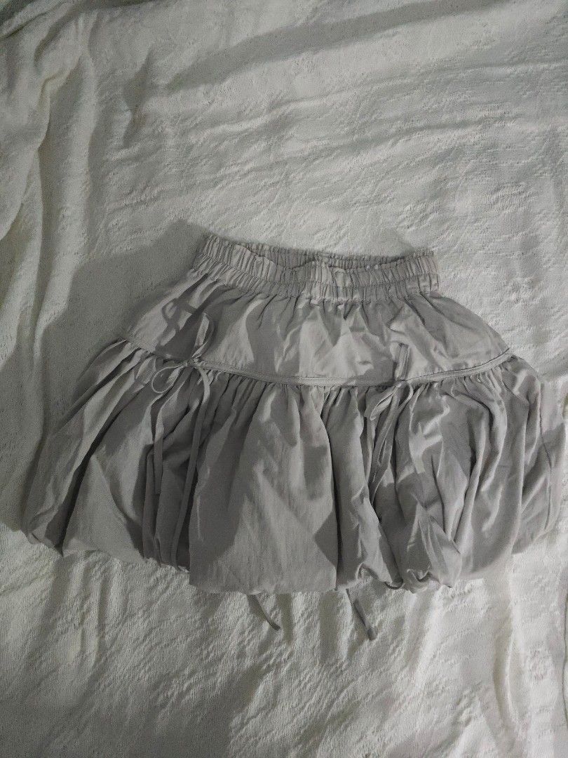 Light Gray Bubble Ribbon Tie Mini Skirt (Category: Skirts) located in Meycauayan. Submitted by saurfee (Listing ID 1448810257, Image 1). Description: - Waist: 55-85 cm - Light grey skirt - Bubble design - Comfortable elastic waistband - Side drawstring detail - Only used once - Has inner shorts - Bought for PHP 850 - Estimated size: Medium - Ideal for casual wear.
