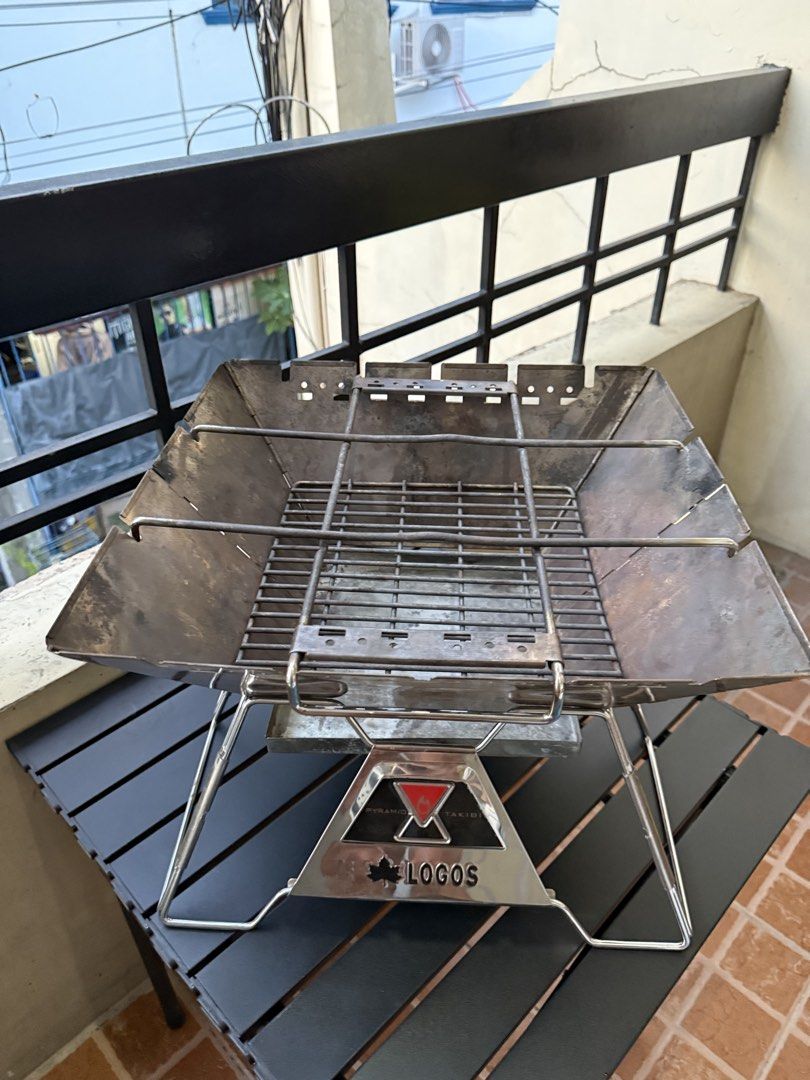 LOGOS Portable BBQ Grill with Carry Bag (Category: Hiking & Camping) located in Paranaque City. Submitted by lourdel018 (Listing ID 1448838561, Image 2). Description: - LOGOS portable BBQ grill - Includes black carry bag - Perfect for outdoor cooking and camping - Durable stainless steel construction - Comes with grill grate and charcoal tray - Folds compactly for easy transport - Shows minor signs of use on metal, fully functional.