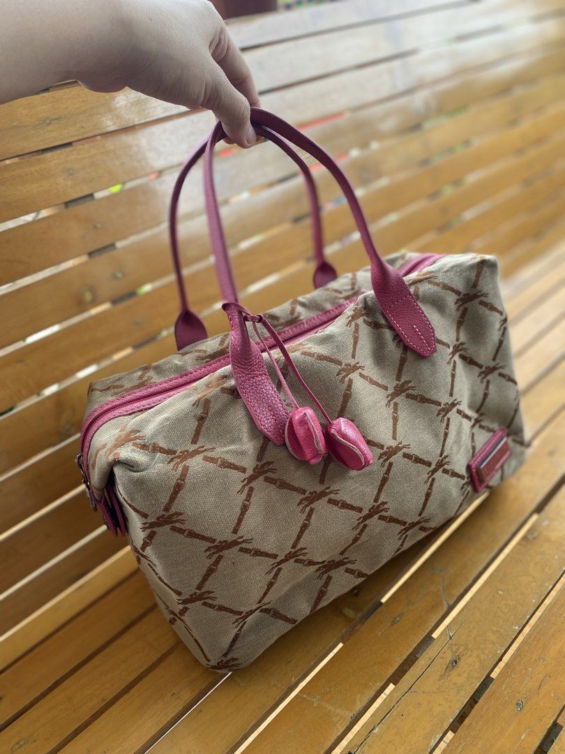 Longchamp Canvas Monogram Shoulder Bag Pink Leather Trim (Category: Shoulder Bags) located in Cadiz. Submitted by saveandstyleph (Listing ID 1448887563, Image 3). Description: - Cute Longchamp bag with classic horse and rider monogram. - Tan canvas body. - Bright pink leather handles and trim. - Zipper closure with tassel detail. - Zipper pull features the Longchamp logo. - Great size for everyday use..