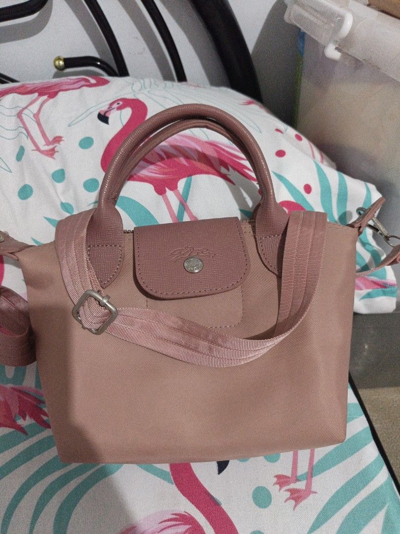 Longchamp Le Pliage Cuir Small Top Handle Bag (Category: Luxury Bags & Wallets) located in Manila. Submitted by epicbird_776b36 (Listing ID 1448798626, Image 1). Description: - Cute pink Longchamp bag - Small size, ideal for everyday use - Top handles and detachable shoulder strap - Nice leather trim detail - Clean interior and exterior - Ready for a new owner!.