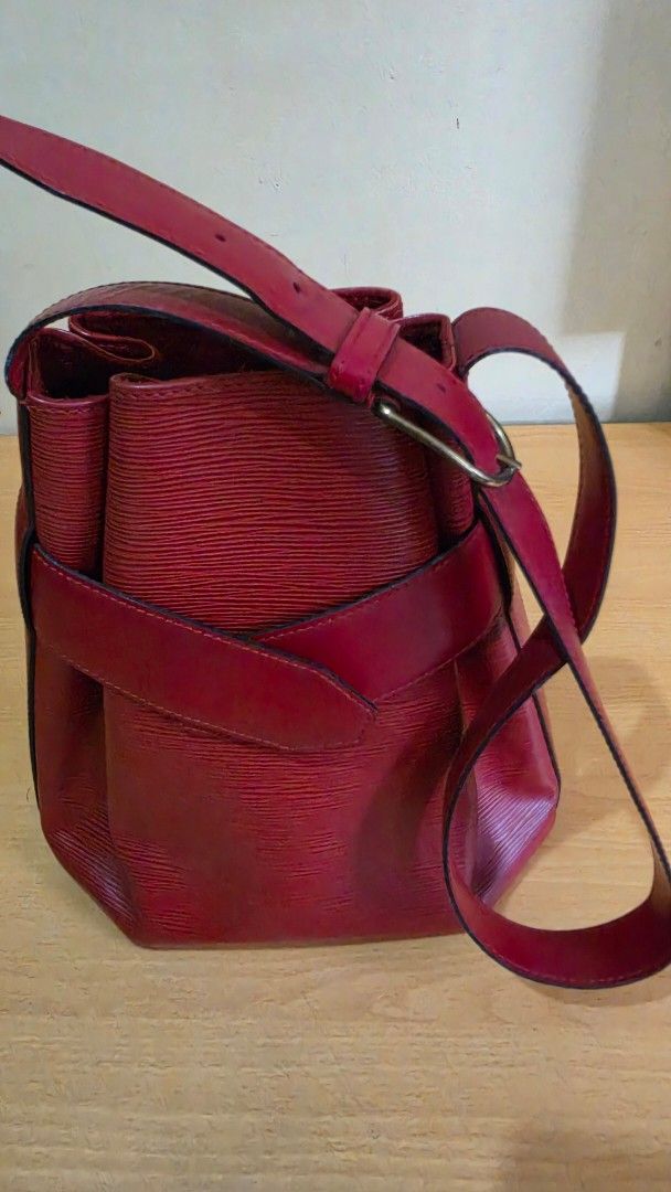 Louis Vuitton Red Leather Handbag Shoulder Bag (Category: Luxury Bags & Wallets) located in Makati City. Submitted by jazz_girl (Listing ID 1448736138, Image 2). Description: - epi leather body - flat genuine leather shoulder strap - open top with snap closure at front - Textured leather finish for a stylish look - Adjustable strap for comfortable wear - Secure flap closure with decorative leather strap detail - Ideal everyday bag for your essent