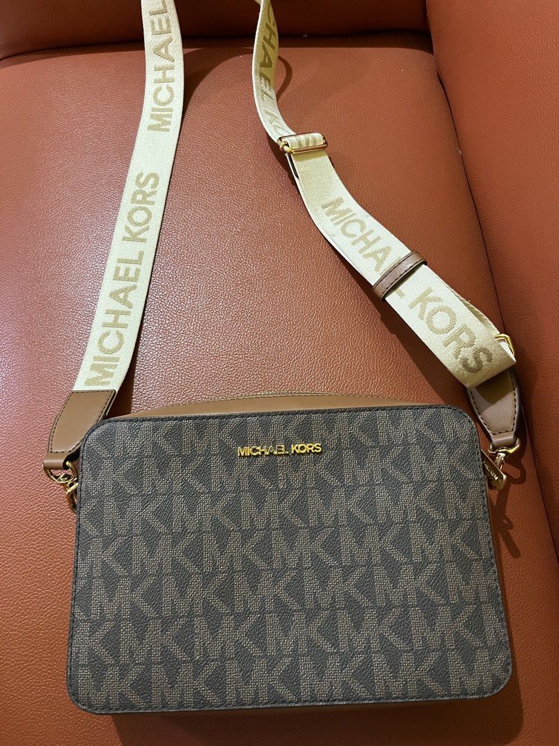 Michael Kors MK Signature Monogram Camera Bag (Category: Luxury Bags & Wallets) located in Bacolod City. Submitted by jem111111 (Listing ID 1448837045, Image 1). Description: - Authentic Michael Kors camera bag - Signature MK print: Brown and beige monogram canvas - Tan leather trim - Adjustable crossbody strap with "MICHAEL KORS" lettering - Gold-tone hardware - Interior: 1 zip pocket, 1 slip pocket - Includes authenticity tag - Ideal for everyd