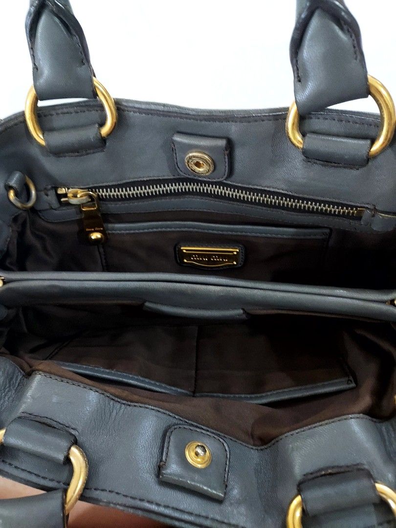 Miu Miu Matelasse Handbag (Category: Luxury Bags & Wallets) located in Paranaque City. Submitted by andim8 (Listing ID 1448757519, Image 3). Description: - Authentic Miu Miu bag with shoulder strap - Color: Dark grey - Material: Gathered leather - Hardware: Gold details - Interior: 1 zip pocket, 2 slip pockets - Condition: Clean inside - Style: Great everyday bag.