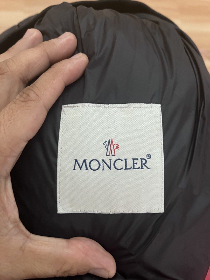 Moncler Black Down Vest with Reflective Detail (Category: Luxury Apparel) located in Victorias. Submitted by lan1877 (Listing ID 1448893364, Image 3). Description: - Moncler black puffer vest - Sleeveless design - Zip-up front closure - Reflective patch on chest - Reflective band at hem - Two side zip pocket - Made in Romania Issue nsa last pics Small pinhole - Down certified Good as new Size medium on tag 22W 27L dimension No issue 1200 plus sf.