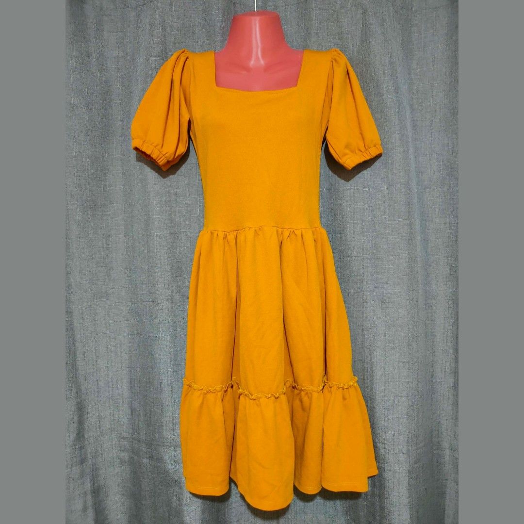 Mustard Puff Sleeve Midi Dress (Category: Dresses) located in Marikina City. Submitted by styledandsassified (Listing ID 1448865176, Image 1). Description: Details: Square neck, short puff sleeves with elastic wrists, multi-tiered ruffled skirt, midi length. Color: Mustard Yellow 💳 MOP: GCash 📦 MOD: 🍊 app checkout.