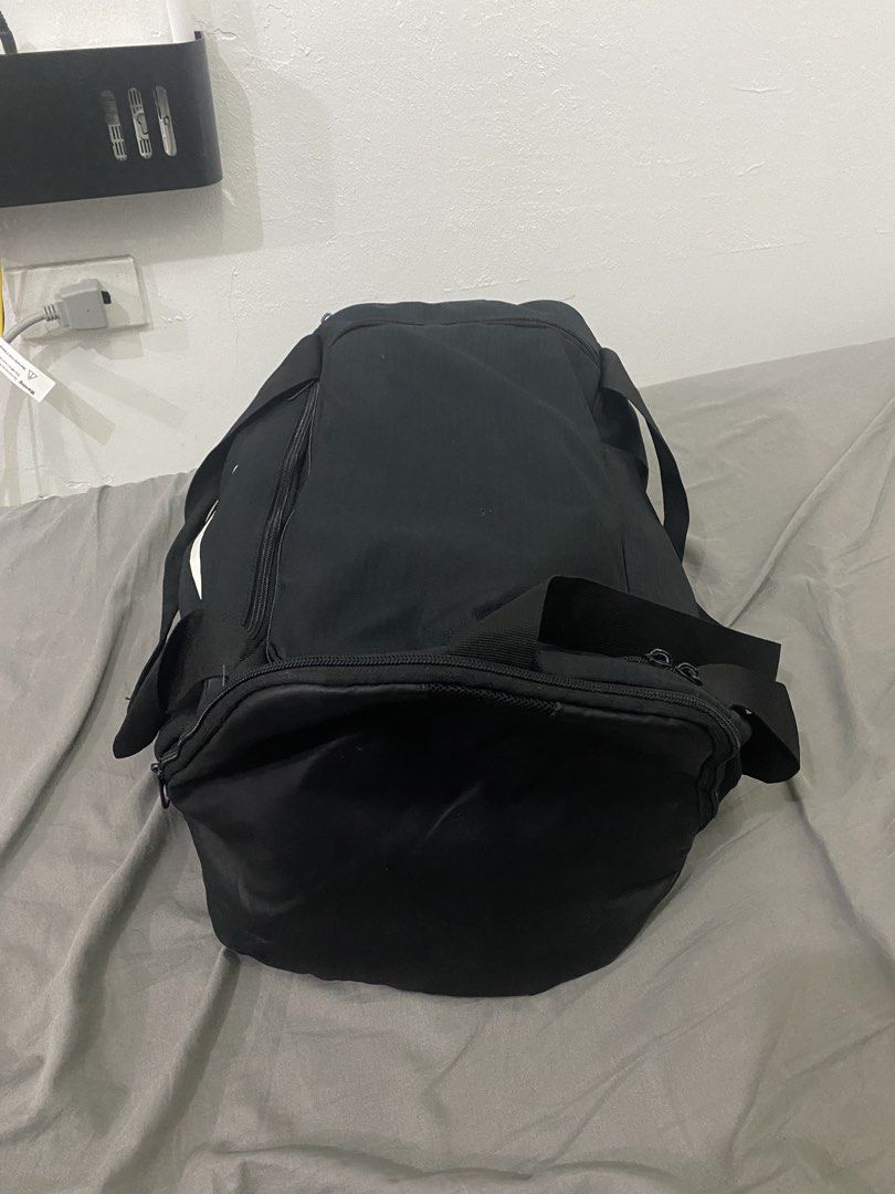 Nike Black Duffel Bag Large Authentic (Category: Sling Bags) located in Makati City. Submitted by hyperdrive_mnl (Listing ID 1448870755, Image 3). Description: - Black Nike duffel bag - Ideal for gym sessions or travel - Spacious main compartment - Convenient side pocket - Adjustable shoulder strap for comfort - Clean interior and exterior - All zippers function smoothly.