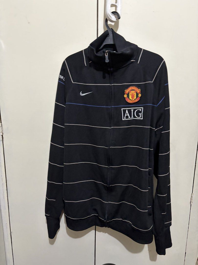 Nike Manchester United 2008-09 Track Jacket (Category: Coats, Jackets and Outerwear) located in Manila. Submitted by wiseearth.075b2f (Listing ID 1448699322, Image 1). Description: - Authentic Nike Manchester United track jacket -₱1765 -Dimension 28 legnth 27 width - 2008-09 season - Color: Black with thin horizontal stripes - Features: Manchester United crest, AIG sponsor logo, Nike swoosh - Condition: Great, check photos for details - Ideal for