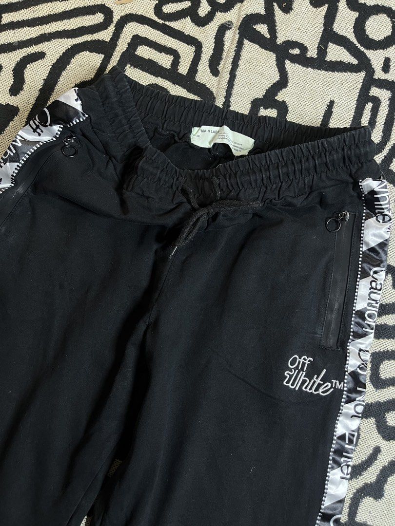 Off-White Black Joggers with Caution Tape Detail (Category: Joggers) located in Silang. Submitted by yusthrift (Listing ID 1448708500, Image 2). Description: - Brand: Off-White - Color: Black - Design: Iconic caution tape along the sides - Features: Elastic waistband with drawstring, ribbed cuffs, two zip pockets - Style: Casual wear 15 inc waistline (30-36) 40 inc length No issue Excellent condition .